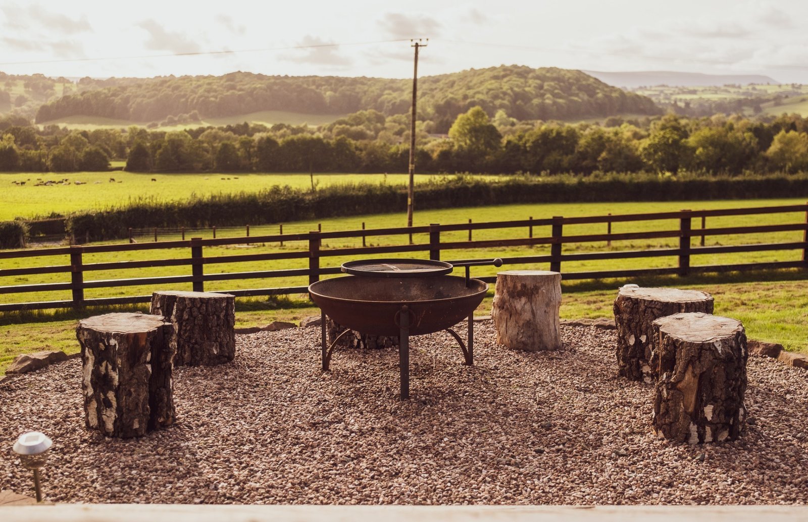 Firepit with tree-stump seats overlooking the valley