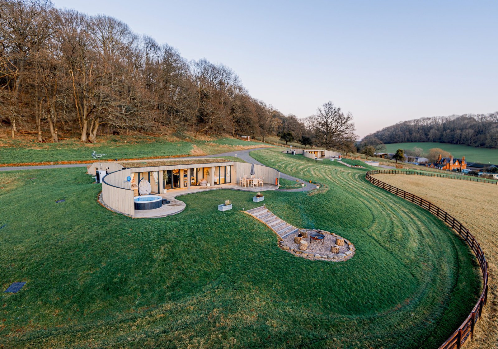 A single Pontypinna lodge, deck and firepit seen from above