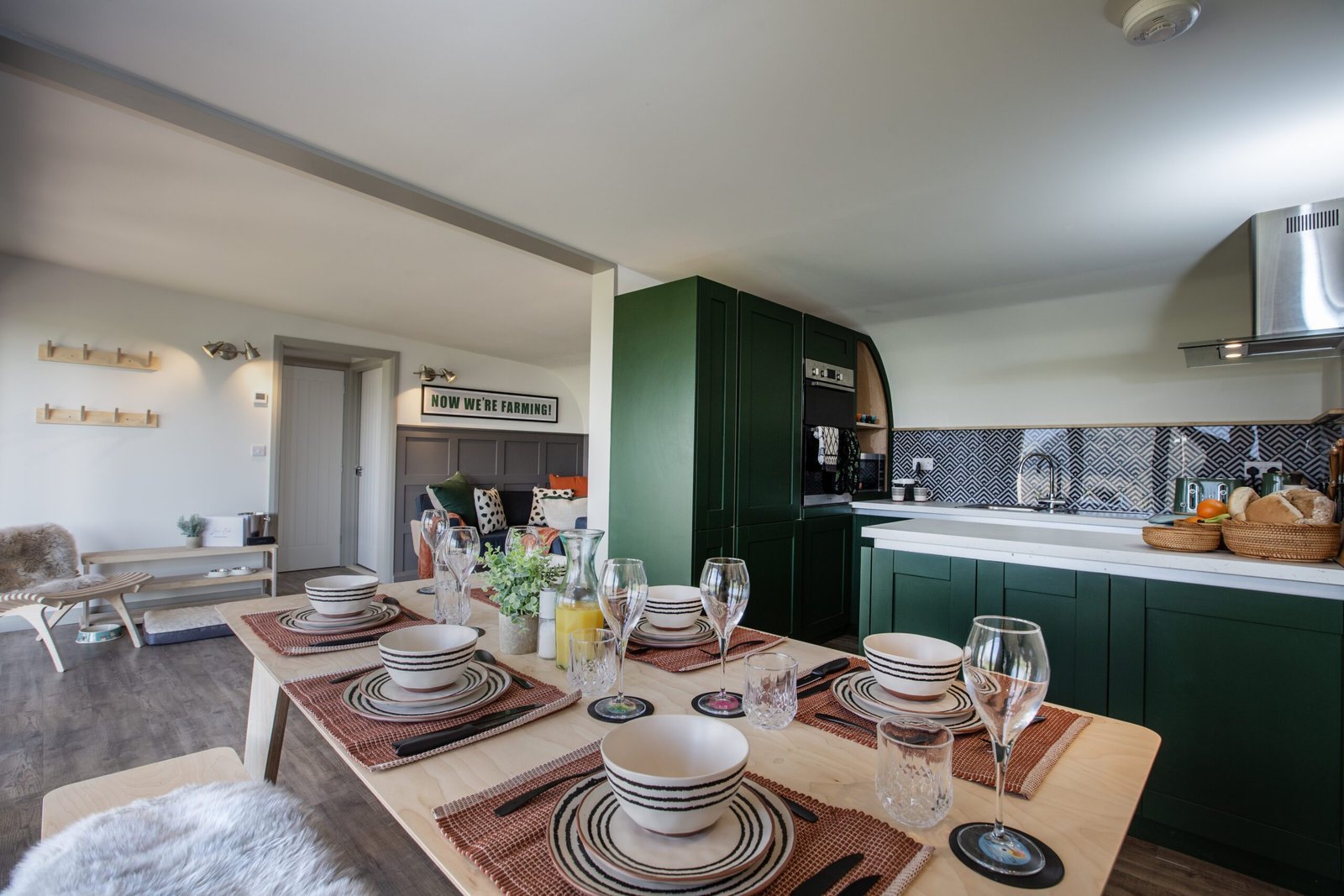 Elegant dining table setup with wine glasses and ceramic plates